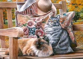 Two cats sitting on a bench